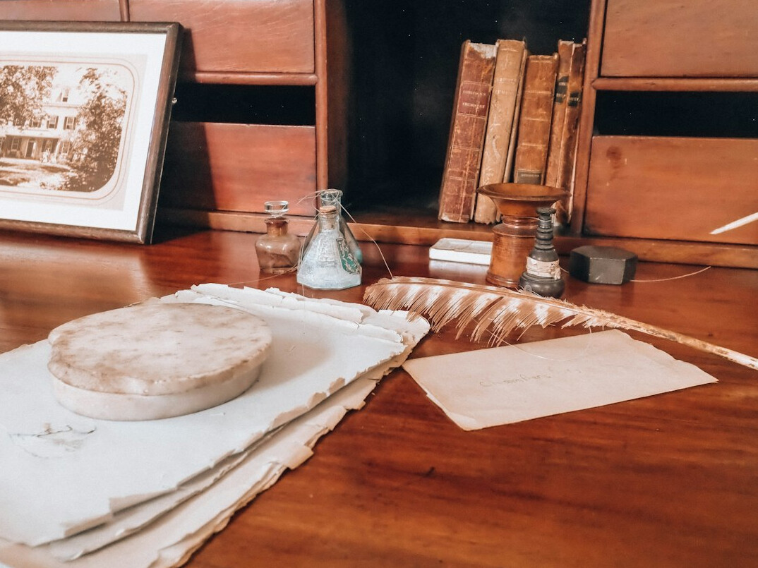 writer at desk with old case files